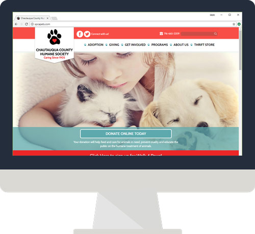 A desktop monitor showing the Chautauqua County Humane Society website