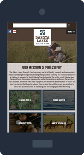 Mobile phone displaying the Dakota Lakes website